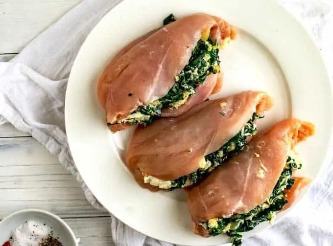 Image of chicken being filled with the spinach and cheese mixture.